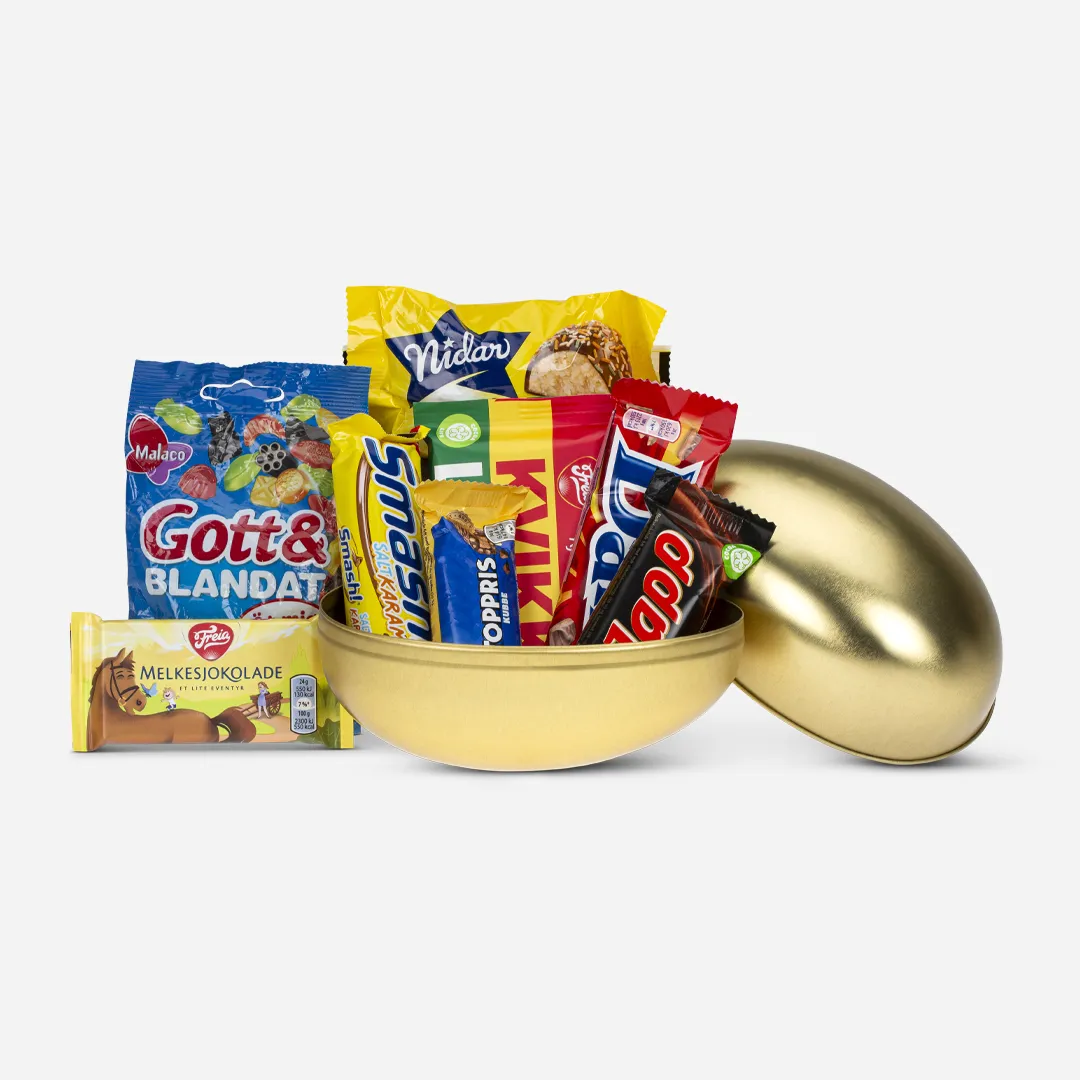 Gullegg 18cm Påskeklassikere - Innhold: Kvikk Lunsj 47g, Melkesjokolade eventyr 24g , Kolibri Marsipanegg 58g, Godt og blandet 40g, Smash Bar salt Karamel 40g, Japp 30g, Daim 28g, Toppris 30g Gullegg delt i to, fylt med sjokolade klassikere