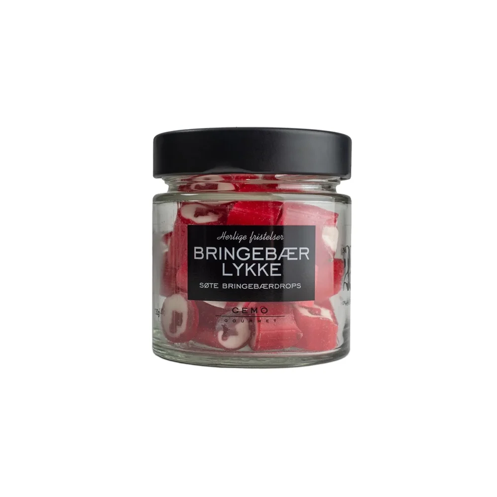 Bringebærlykke Drops (historisk) - Søte små hjerter i drops med smak av bringebær. Med en frisk og god smak har disse dropsene også et hint av nostalgi. Den perfekte gaven til den som elsker søte bringebær. Gjennomsiktig glass med sort lokk. Glasset er fylt med bringebærlykke drops