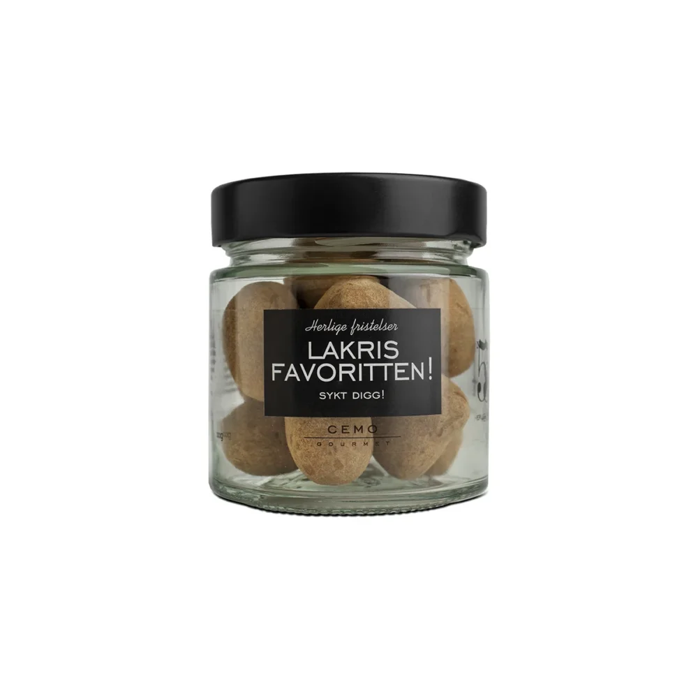 Lakrisfavoritten (historisk) - Salt lakris dekket med hvit sjokolade og salmiakkpulver. En klar favoritt som forsvinner først fra godteskåla! Gjennomsiktig glass med sort lokk. Glasset er fylt med dragert lakris